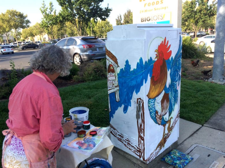 Artist Karen Fulk prepares to paint a utility box in Yuba City.
